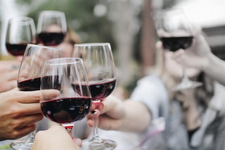 Guests raising a toast at a Destin Charity Wine Auction Foundation event
