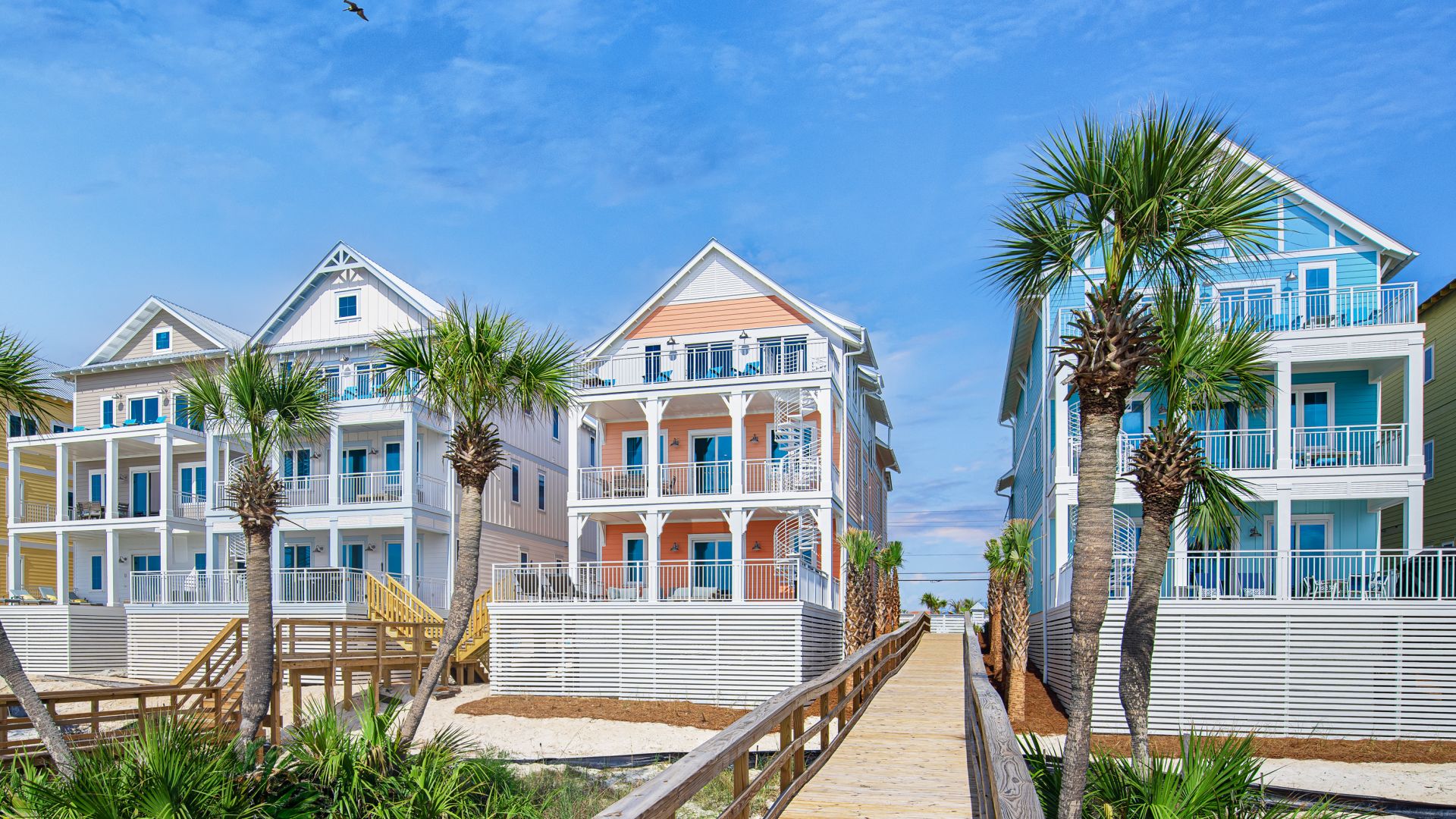 Beach boardwalk leading to a row of vacation homes at Margaritaville Beach Cottage Resort
