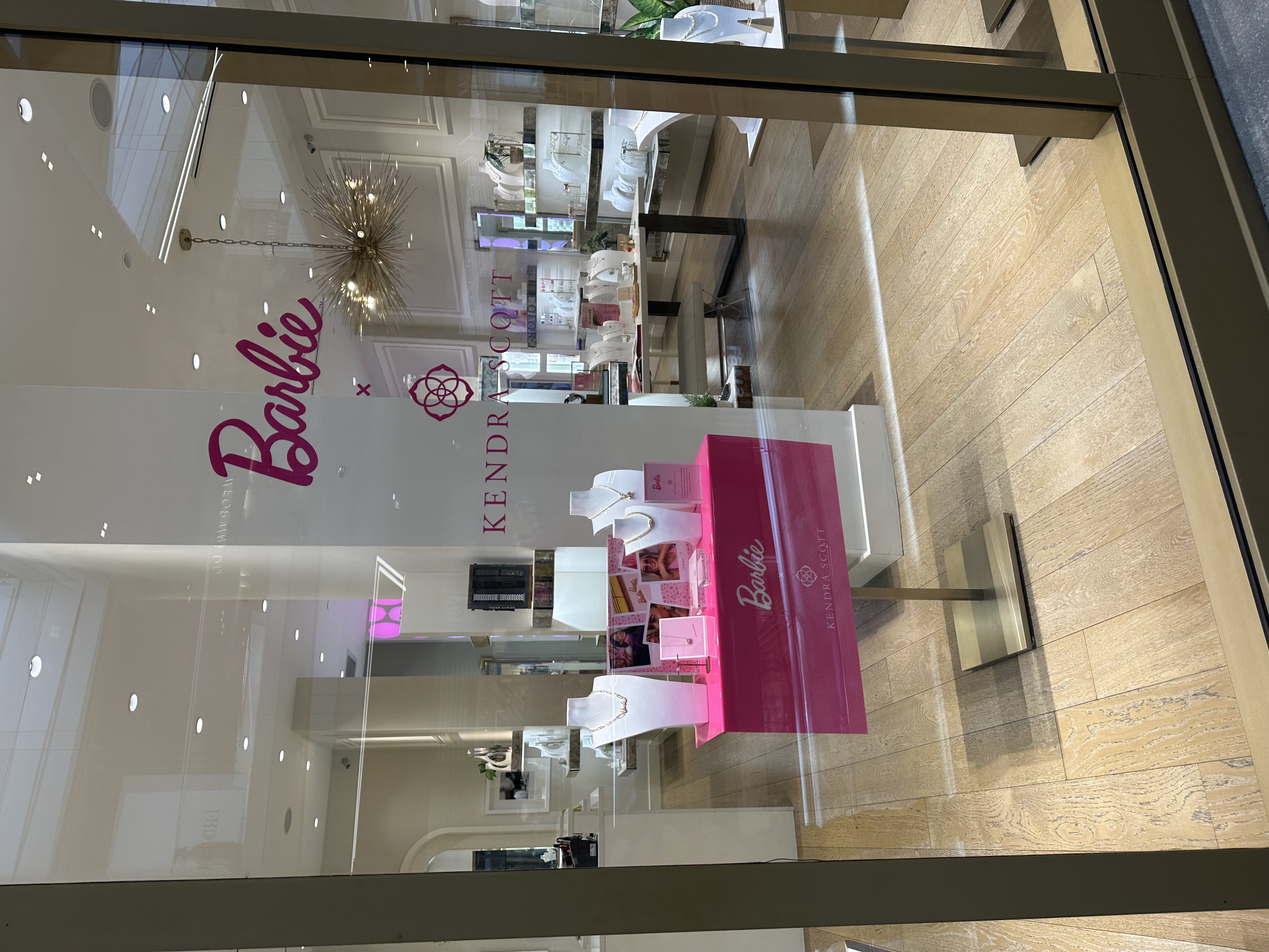 Interior of a Kendra Scott jewelry store showing display cases and signage