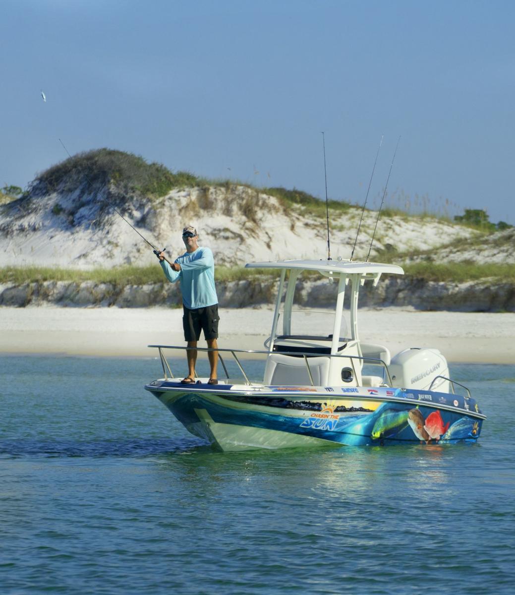 A charter boat running through the emerald green Gulf waters near Panama City Beach