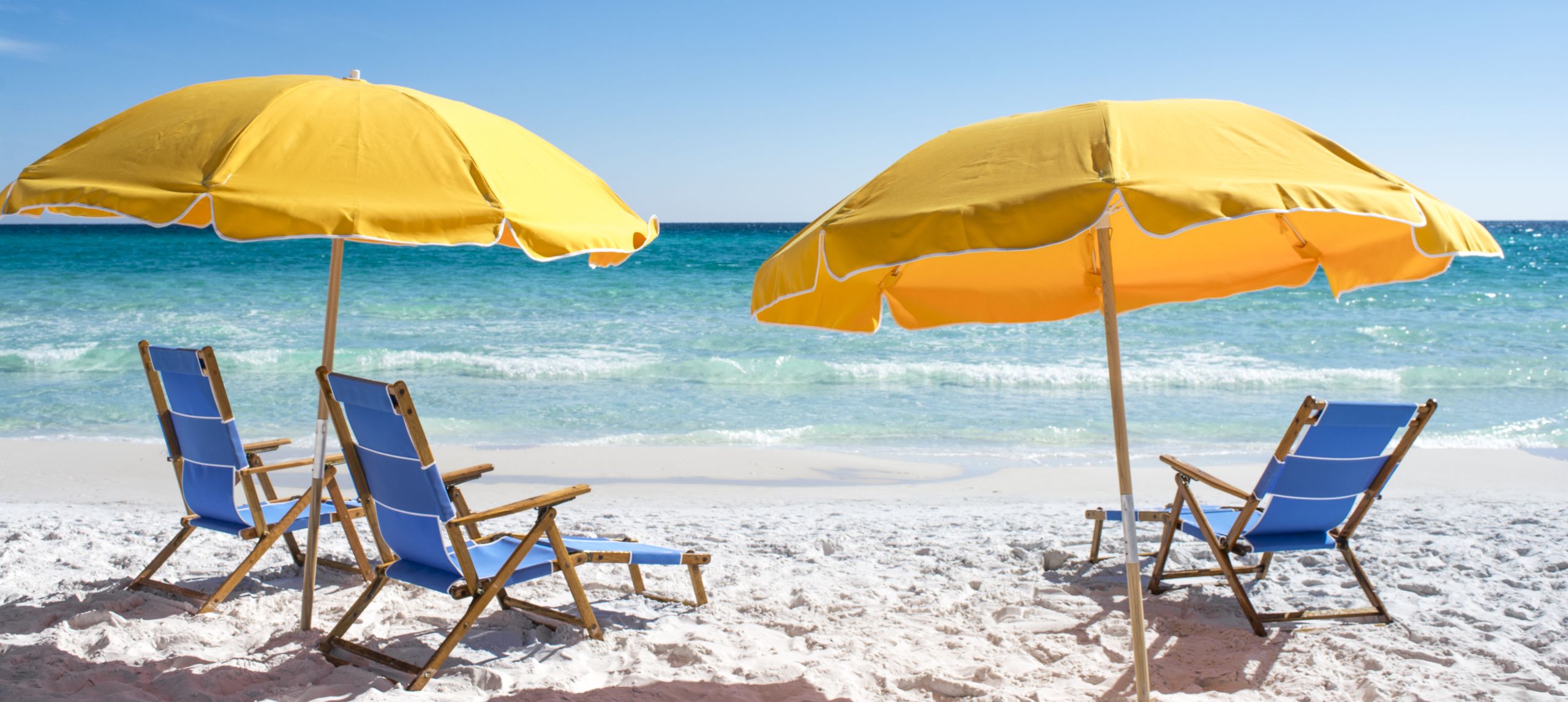 Beach chairs and umbrellas set up on the private beach at Hilton Sandestin Beach Golf Resort & Spa