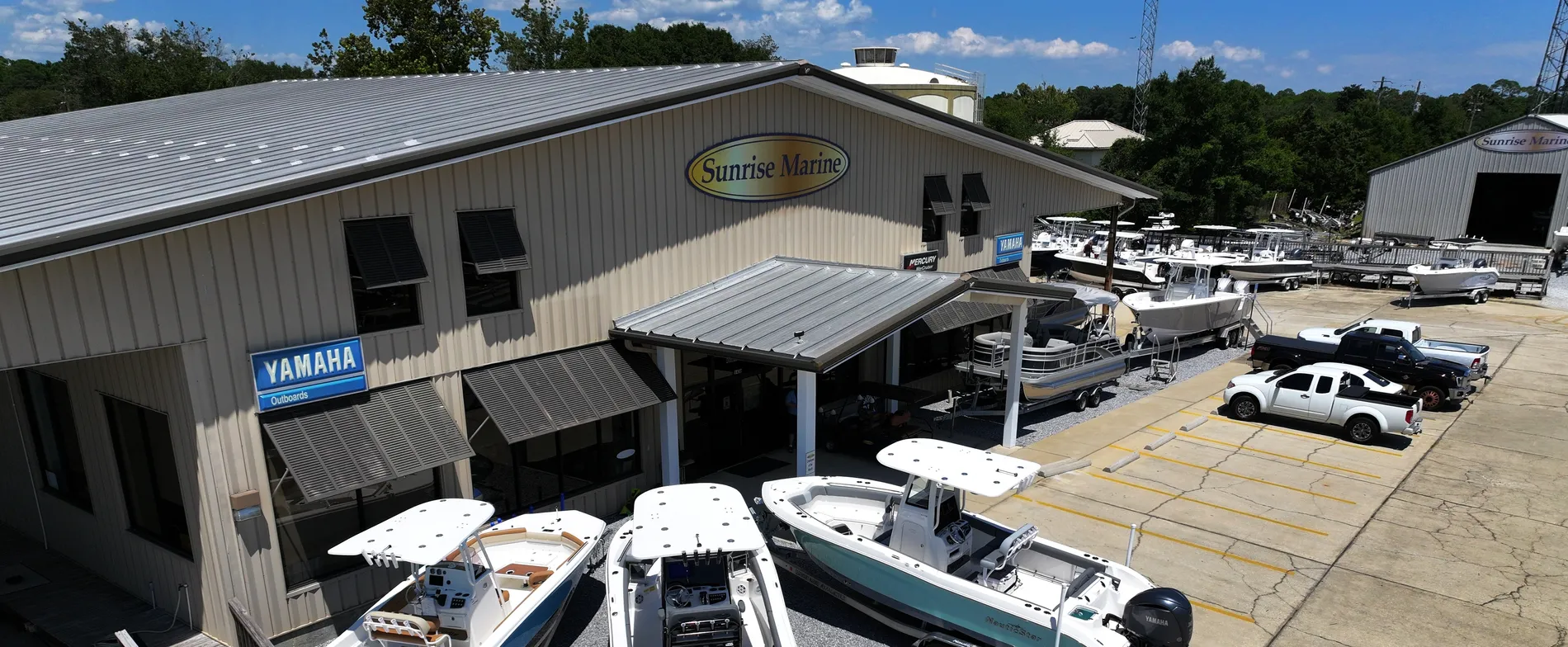 Aerial view of the Sunrise Marine boat dealership and lot in Mary Esther, Florida