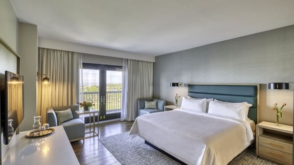 Deluxe King balcony room at Hotel Effie Sandestin with coastal design and bay view