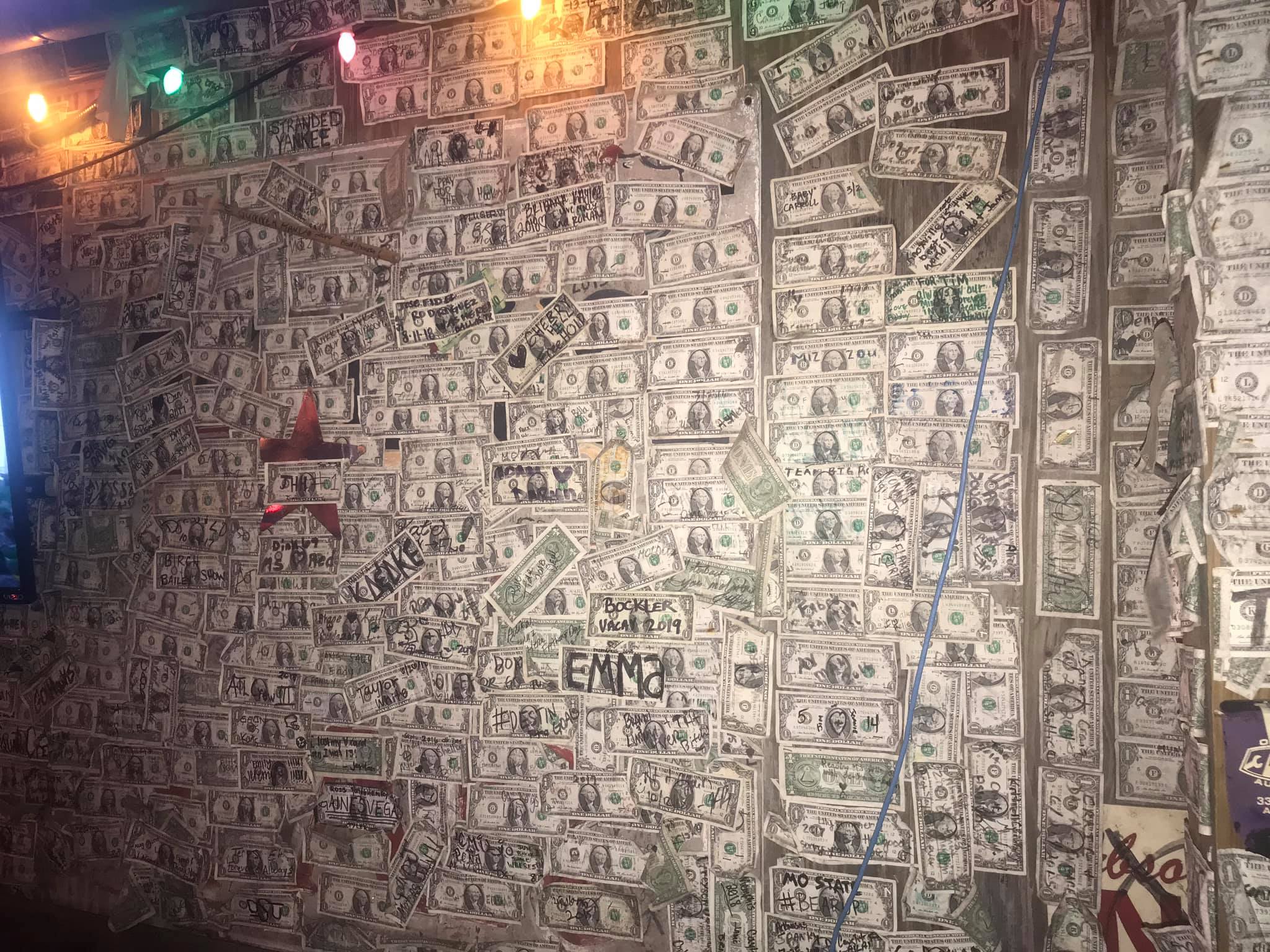 Interior of Boathouse Oyster Bar on Destin Harbor covered in signed dollar bills
