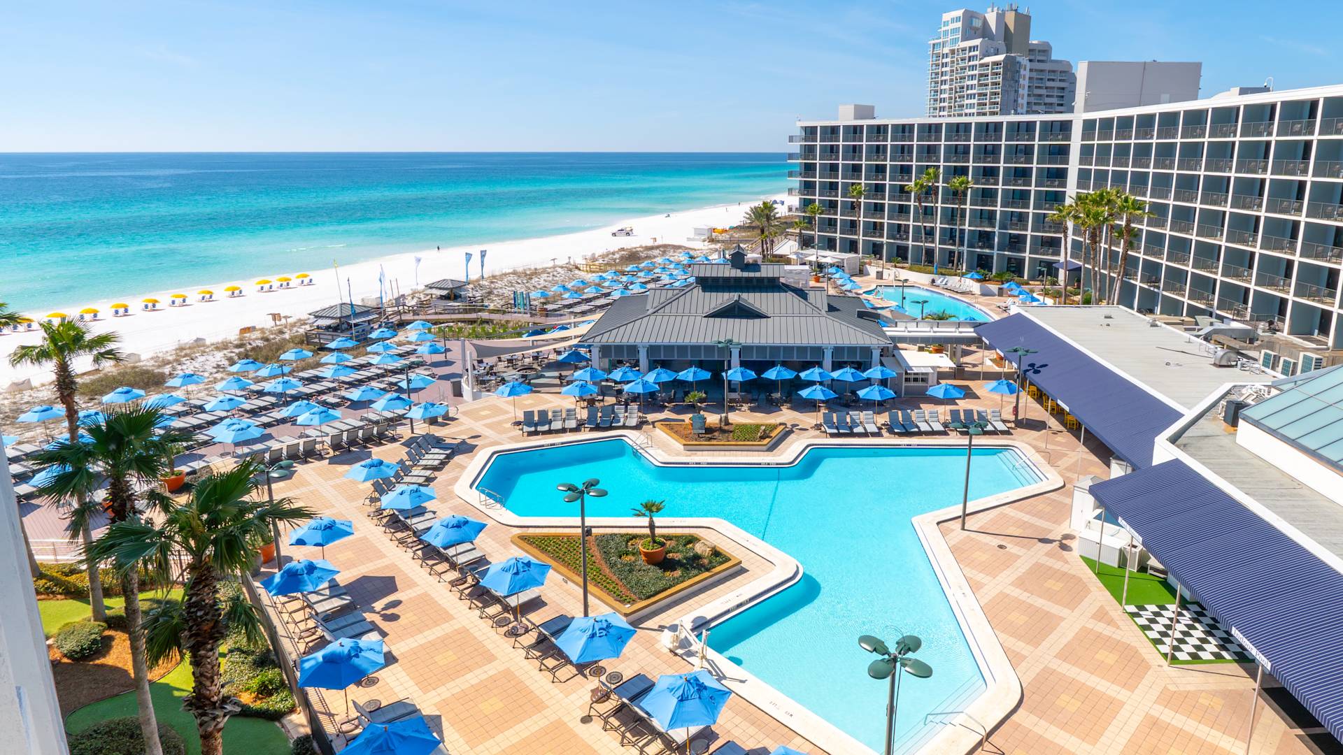Pool deck at Hilton Sandestin Beach Golf Resort & Spa with the Gulf of Mexico in the background