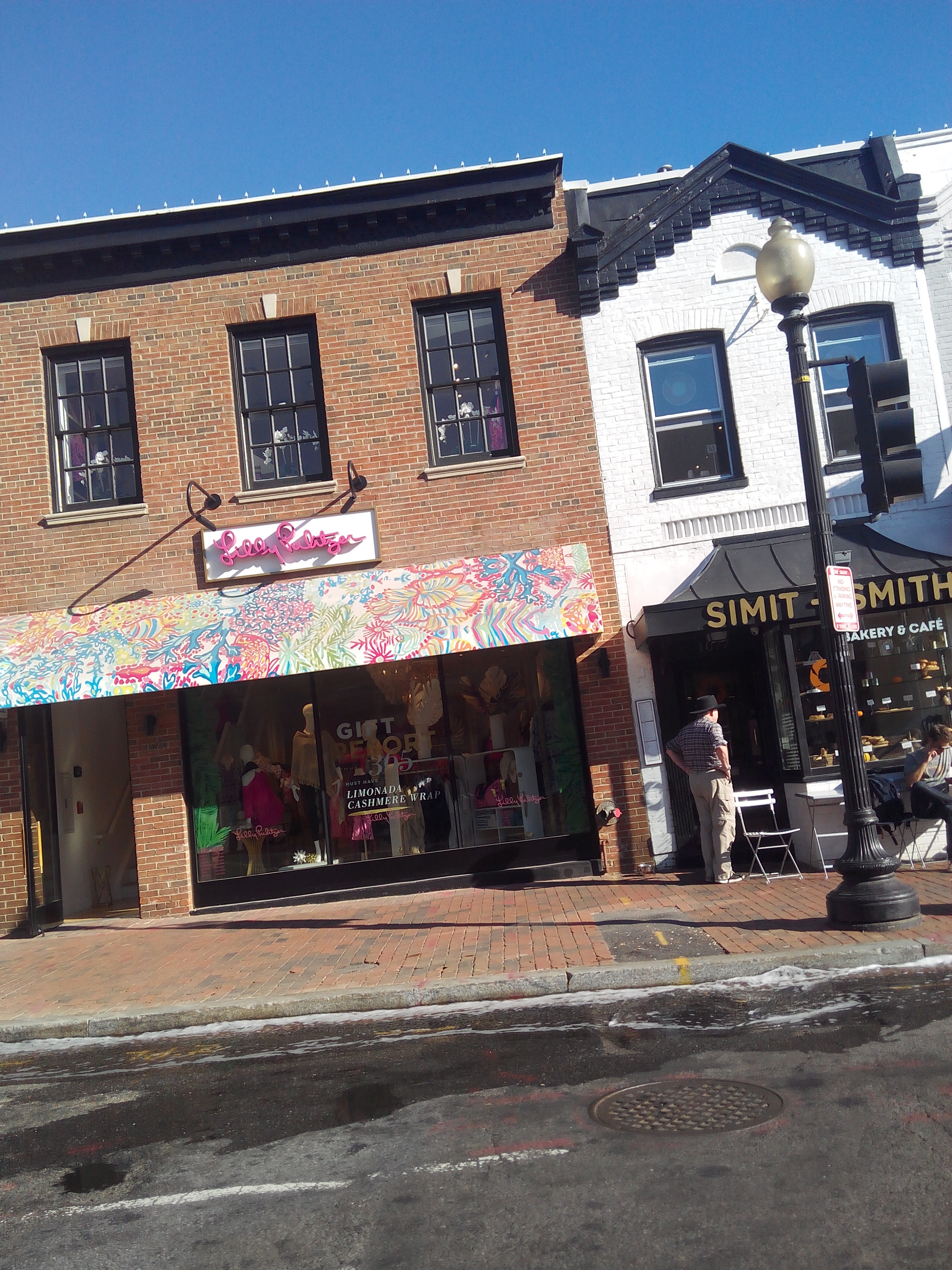 Lilly Pulitzer storefront with pink signage and colorful printed awning