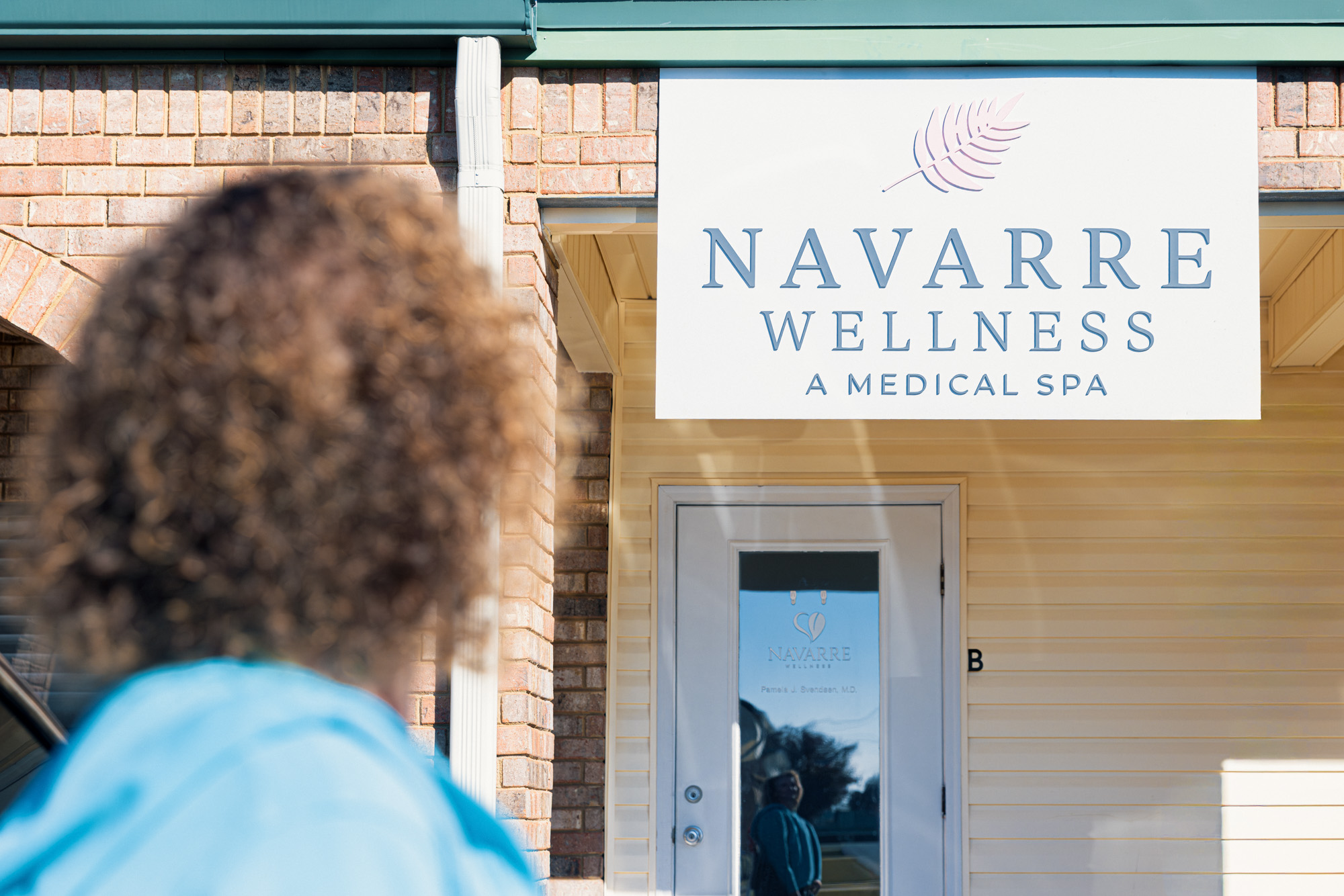 Exterior of the Navarre Wellness medical spa building on Navarre Parkway