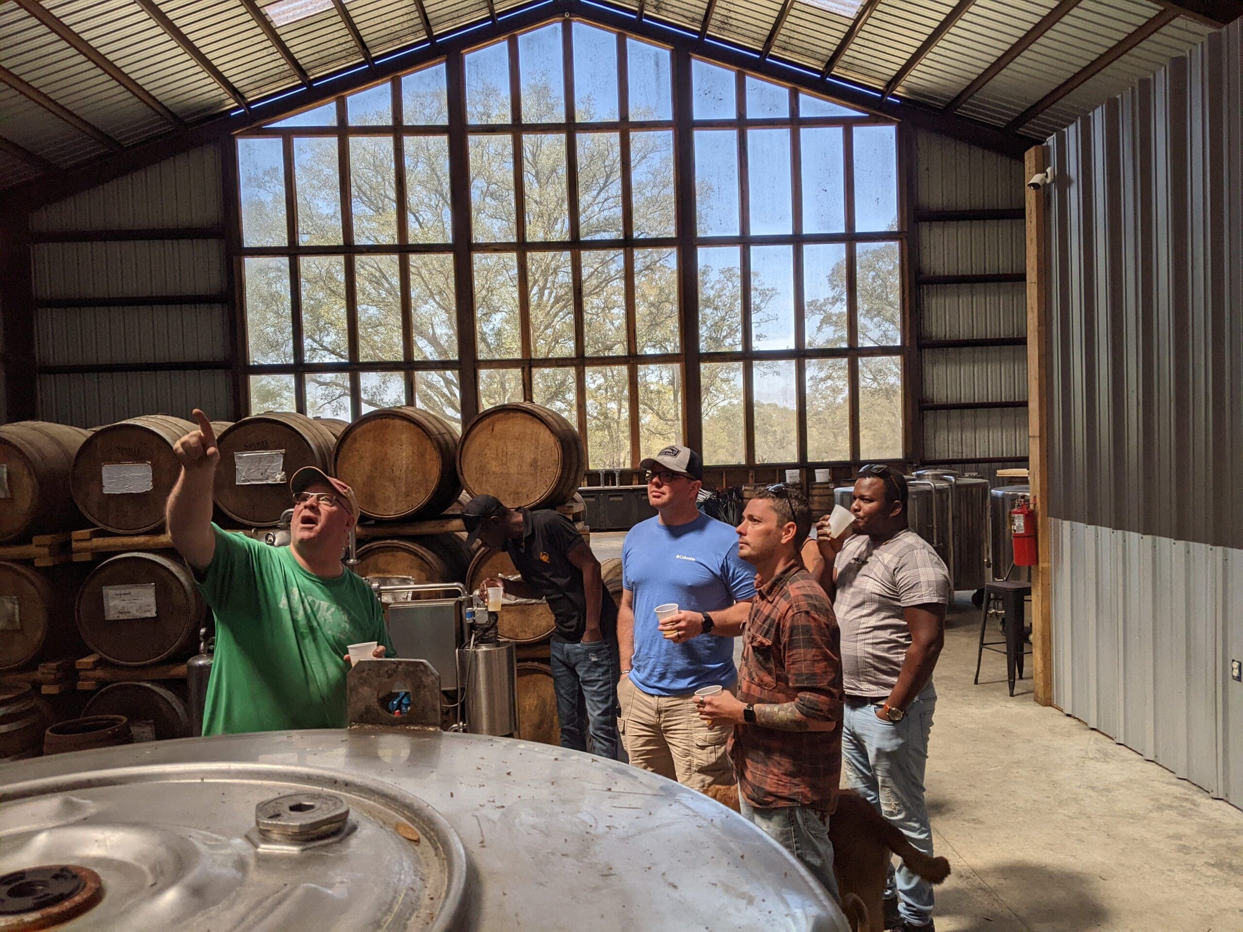 Tour guide explaining the still to visitors during a distillery tour at Timber Creek