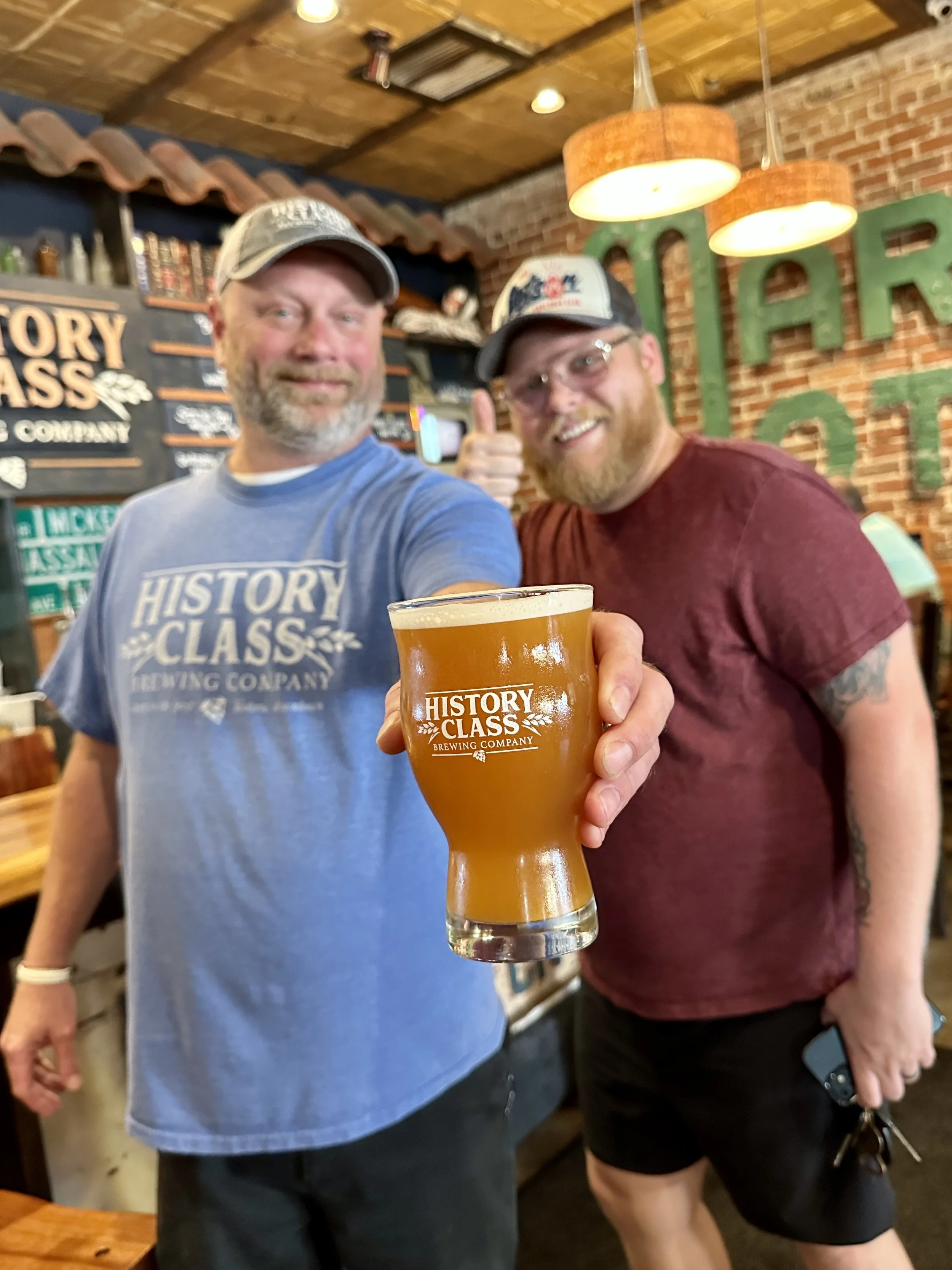 Staff pouring beers at History Class Brewing Company in downtown Panama City