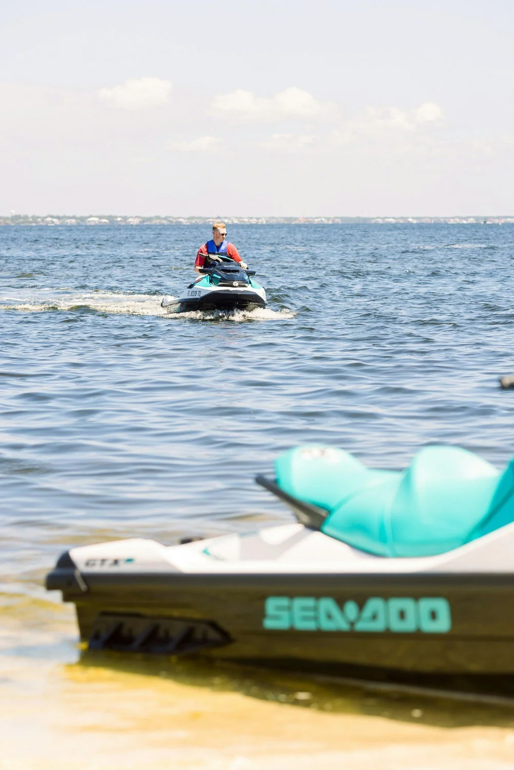 Jet skis lined up for rental at Radical Rides on Pensacola Beach