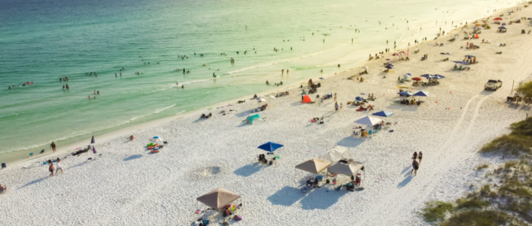 Beachgoers on the white sand at Miramar Beach