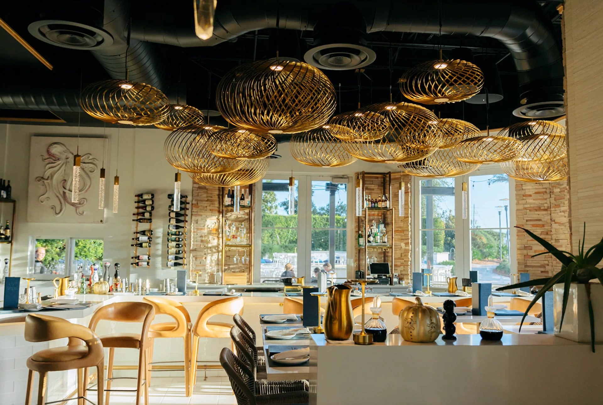 Aja 30A Inlet Beach restaurant interior with golden lighting and modern decor