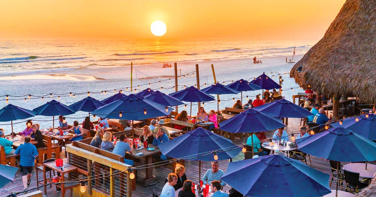 Dining deck and tiki hut atmosphere at Sharky's Beachfront Restaurant