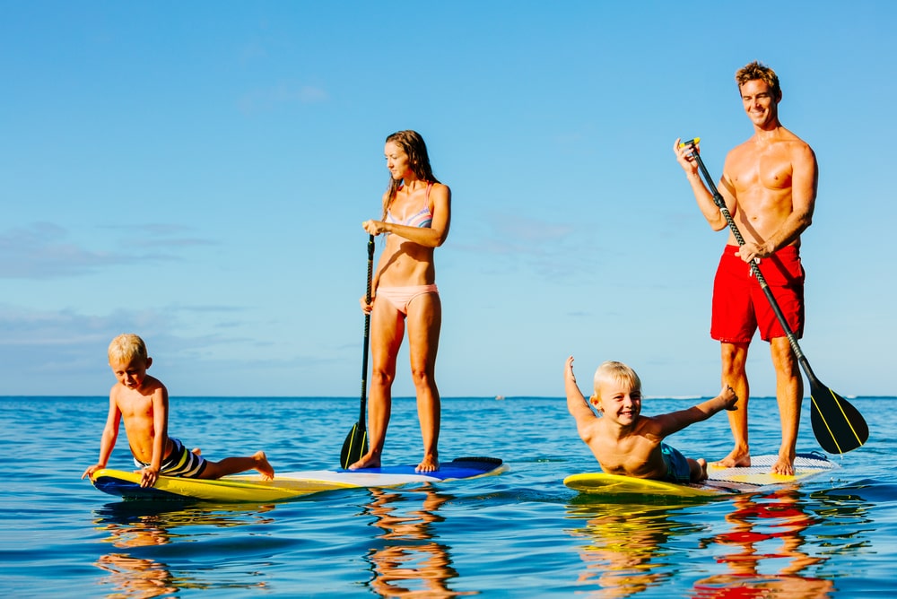 Kayaks and paddleboards lined up for rental at The Rental Shop 30A in Santa Rosa Beach