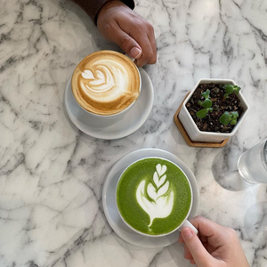 Lattes on a marble table at 2 Birds Cafe