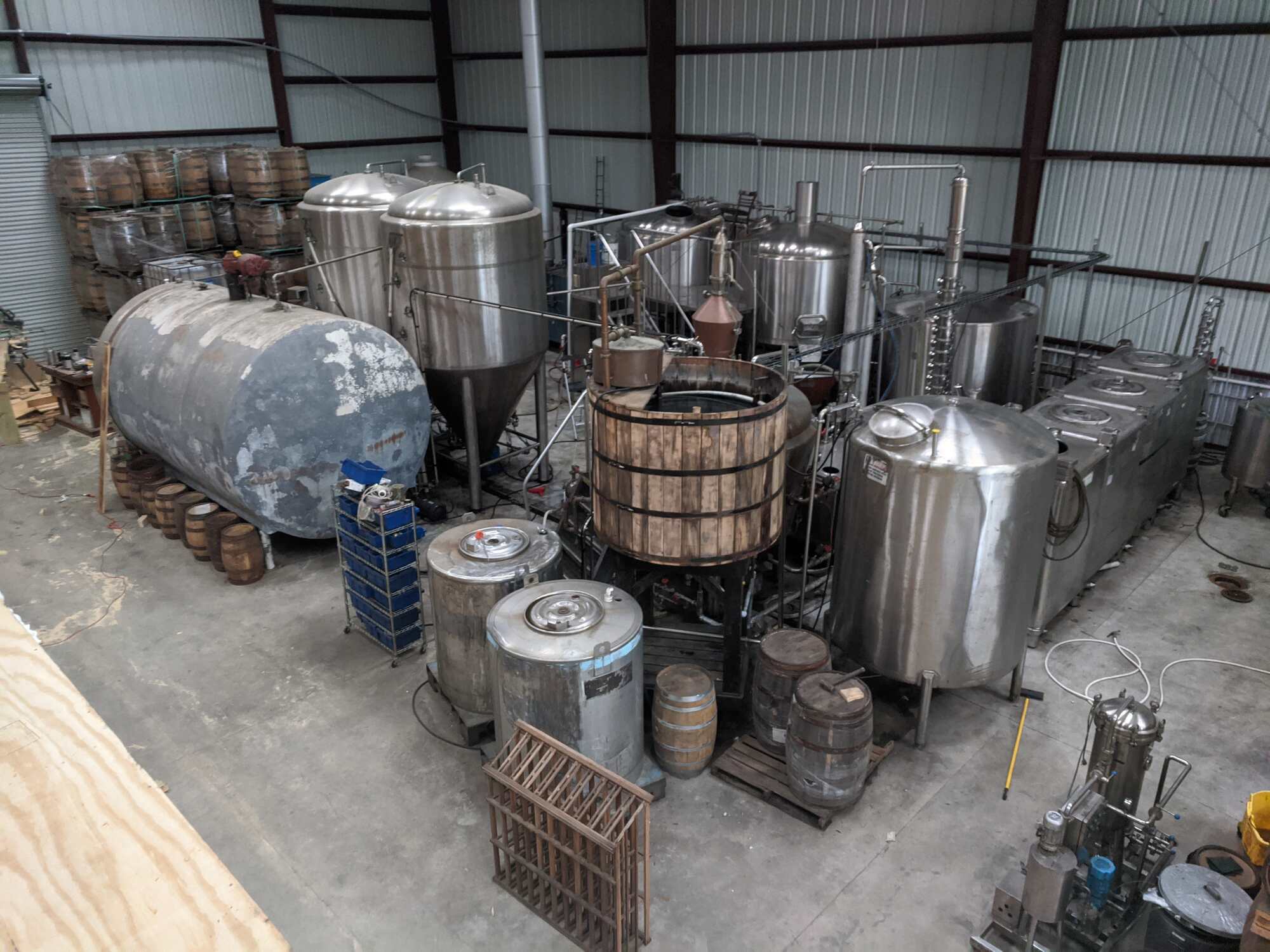 Overhead view of fermentation tanks and mash tun inside Timber Creek Distillery