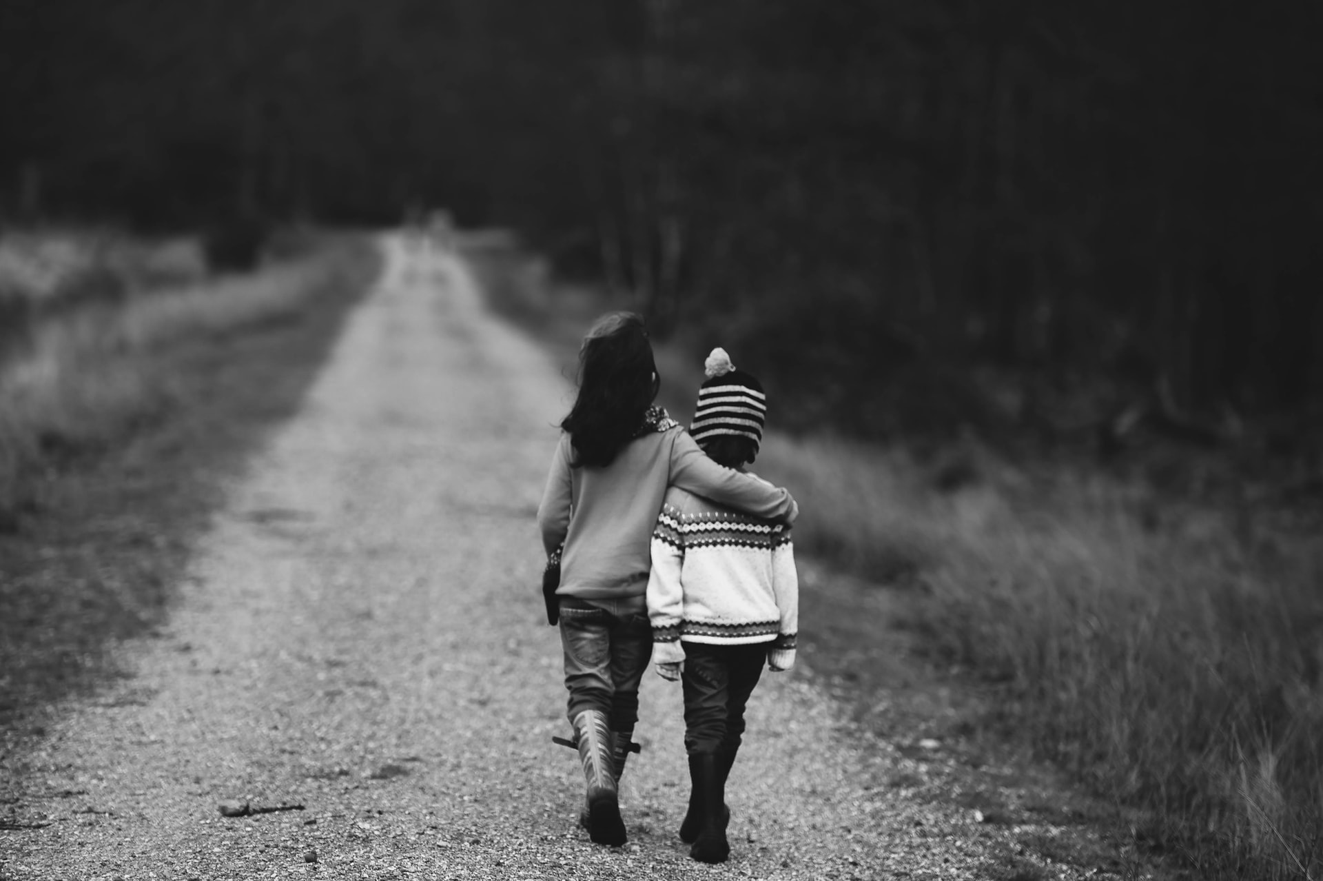 Two children walking together, representing the youth served by Destin Charity Wine Auction Foundation beneficiaries