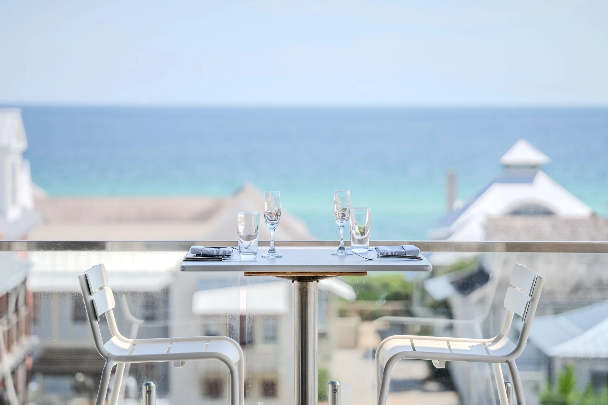 Rooftop dining and bar area at Pescado Seafood Grill & Rooftop Bar with Gulf views in Rosemary Beach