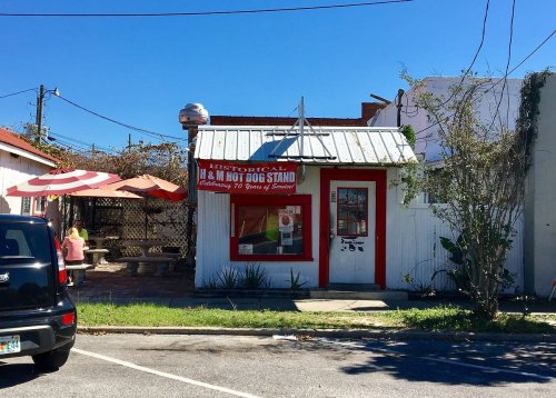 Counter and grill setup inside the small H&M Hot Dogs stand in DeFuniak Springs