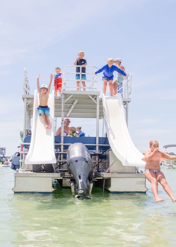 Double decker pontoon boat with a water slide rented from LDV Sandestin Watersports at Sandestin