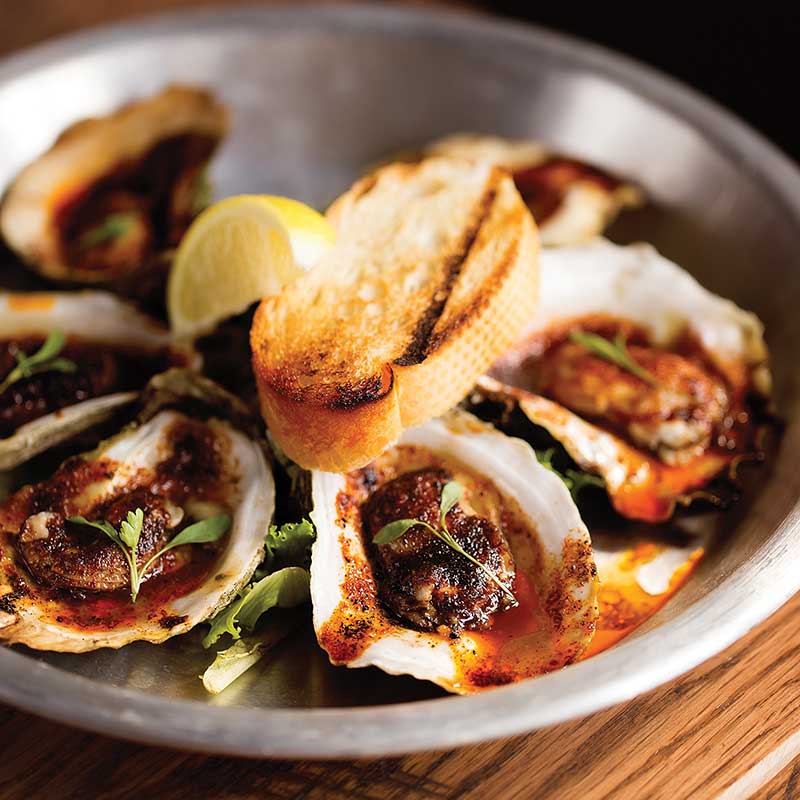 Chargrilled oysters served at Slick Lips Seafood and Oyster House