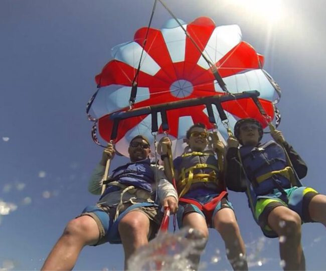 Parasailer flying above the water near Xtreme H2O in Destin