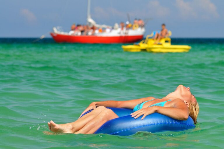 Woman floating on an inner tube in emerald water near Fort Walton Beach