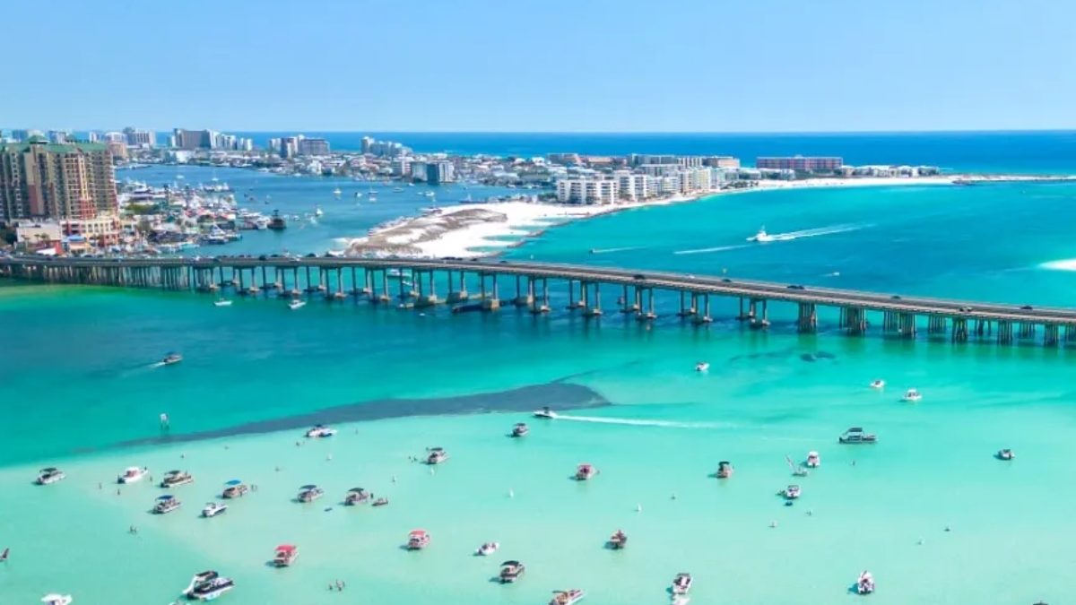 Boats anchored at Crab Island with the Marler Bridge and Destin skyline behind, Destin, Florida