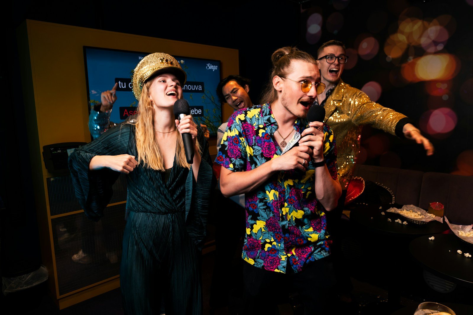 Group singing karaoke in a party room