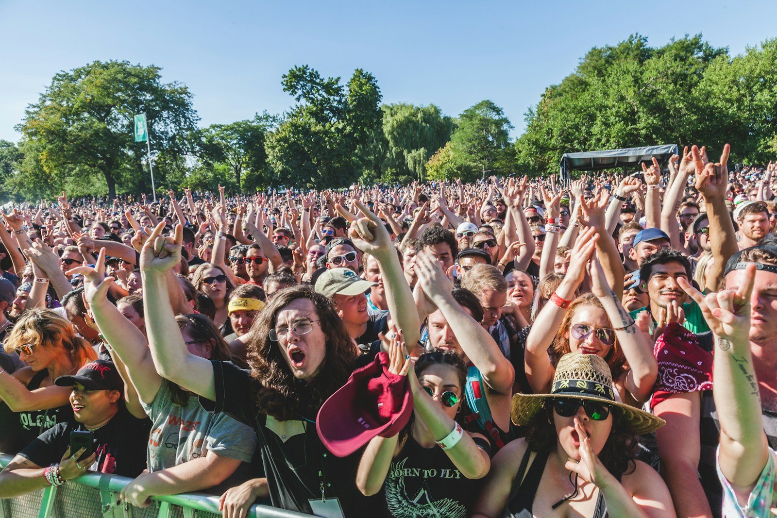 Crowd with hands raised at an outdoor concert